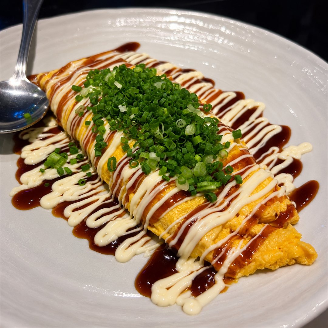 Japanese omelette with tonkatsu sauce, mayonnaise and spring onion